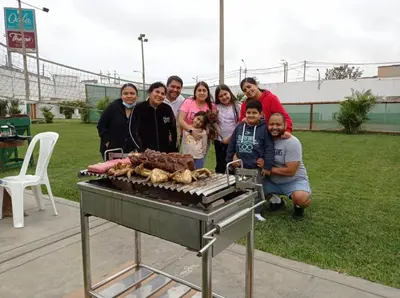 a group of people posing in front of a grill at Qala Hotels & Resorts in Chincha Alta