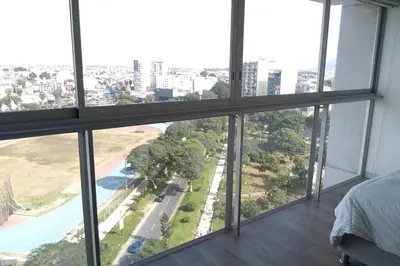 a bedroom with a view of a city at Barranco Penthouse ocean boardwalk in Lima
