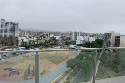 a view of a city with a beach and buildings at Barranco Penthouse ocean boardwalk in Lima