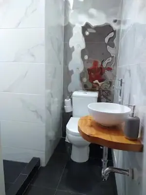 a bathroom with a white toilet and a sink at Barranc Group Penthouse in Lima