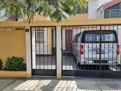 a van parked inside of a garage with gates at Apart Hotel Don Ernesto in Lima