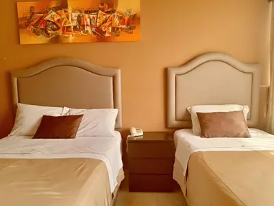 two beds sitting next to each other in a room at Gran Hotel Ica in Ica
