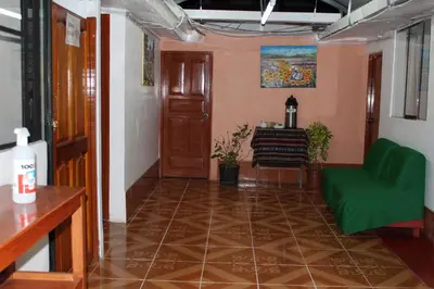 a living room with a green couch and a table at KAARO HOUSE CUSCO in Cusco