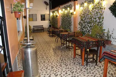 a restaurant with tables and chairs in a room at KAARO HOUSE CUSCO in Cusco