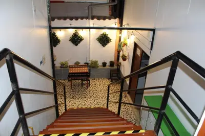 a stairway with two benches and wreaths on the wall at KAARO HOUSE CUSCO in Cusco