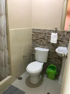 a bathroom with a toilet and a sink at Rooms MD in Huancayo