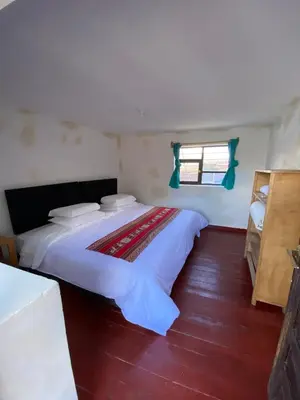 a large bed in a room with a window at CASA ANDINA PRIVADA a lado del Museo - Qespiwanka in Urubamba