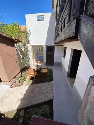 an external view of a building with a table and bench at CASA ANDINA PRIVADA a lado del Museo - Qespiwanka in Urubamba