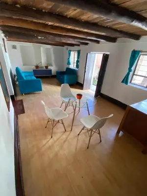 a living room with white chairs and a blue couch at CASA ANDINA PRIVADA a lado del Museo - Qespiwanka in Urubamba