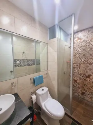 a bathroom with a toilet and a sink and a shower at Departamento exclusivo ica in Ica