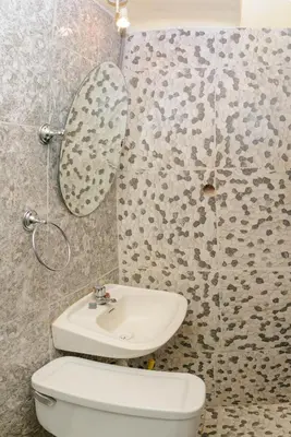 a bathroom with a toilet and a sink and a mirror at Hostal Chasky in Cusco