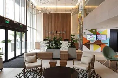 a lobby with chairs and a table in a building at Casa Andina Standard Benavides in Lima