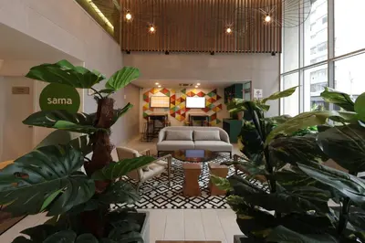 a living room with a couch and some plants at Casa Andina Standard Benavides in Lima