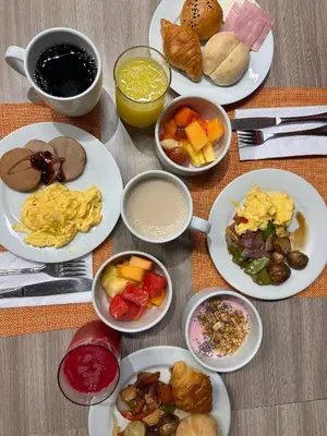 a table with plates of food and bowls of breakfast foods at Casa Andina Standard Benavides in Lima