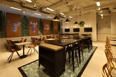 a restaurant with tables and chairs in a room at Casa Andina Standard Benavides in Lima