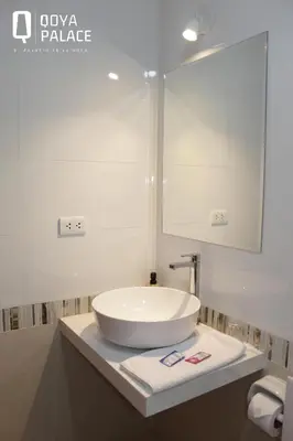 a bathroom with a white sink and a mirror at Hotel Qoya Palace - Machupicchu in Machu Picchu