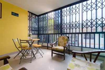 a room with chairs and a table and a window at Hotel Savoy Ica in Ica