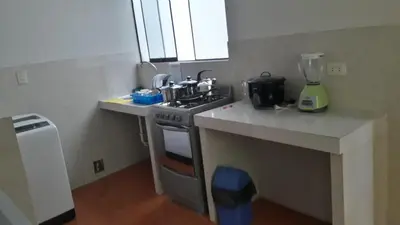 a kitchen with a stove and a counter top at Hermoso departamento en chorrillos in Lima