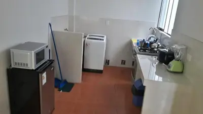 a small kitchen with two refrigerators and a microwave at Hermoso departamento en chorrillos in Lima