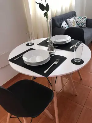 a white table with plates and utensils on it at Hermoso departamento en chorrillos in Lima