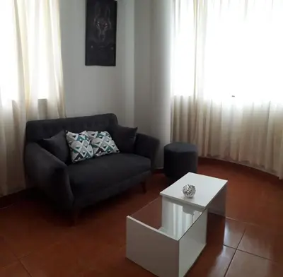 a living room with a couch and a coffee table at Hermoso departamento en chorrillos in Lima