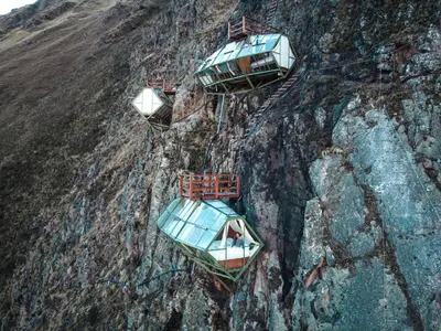a group of boats on the side of a mountain at Vertical Sky Suites in Ollantaytambo