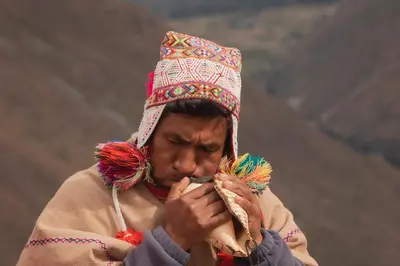 a man wearing an indian headdress and wearing at Vertical Sky Suites in Ollantaytambo