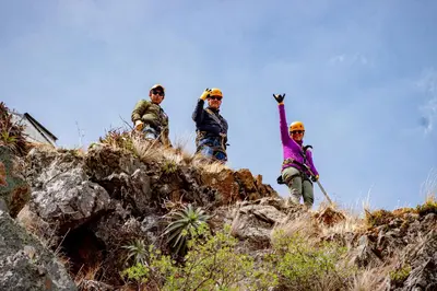 a group of three people standing on a hill at Vertical Sky Suites in Ollantaytambo