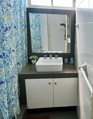 a bathroom with a sink and a mirror at Paracas Paracas! Vista Bahia - Sotavento 201 T 6 in Paracas