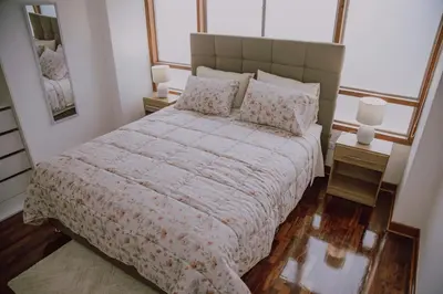 a bedroom with a large bed and two night stands at Departamento Premium De Estreno En Miraflores in Lima