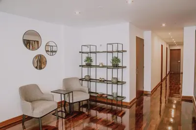 a living room with two chairs and a table at Departamento Premium De Estreno En Miraflores in Lima