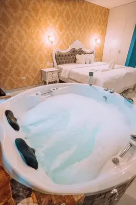 a bath tub in a room with a bed at Lima Central Design Hotel Spa & Club in Lima