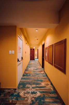 a hallway with yellow walls and a tile floor at Lima Central Design Hotel Spa & Club in Lima
