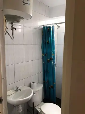 a bathroom with a toilet and a shower and a sink at 300 Departamento Centrico distrito de chorrillos in Lima