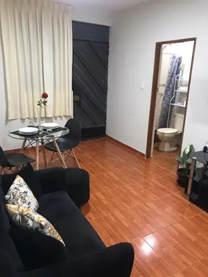 a living room with a couch and a table at 100- departamento céntrico en chorrillos in Lima