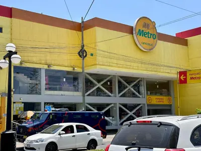 a mexican store with cars parked in front of it at 100- departamento céntrico en chorrillos in Lima