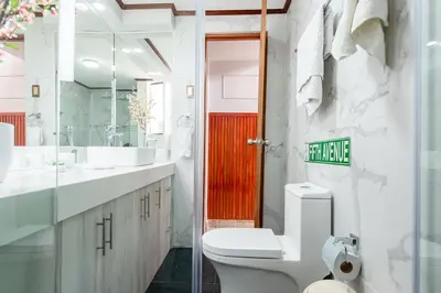 a bathroom with a toilet and a sink and a red door at Loft abierto y moderno & Aire acondicionado in Lima