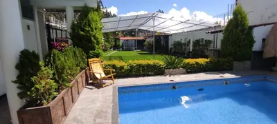 a swimming pool in the backyard of a house at Villa blanca in Andahuaylas