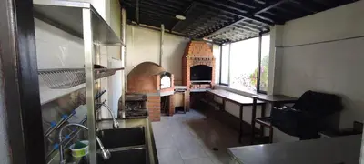 a kitchen with a pizza oven in a room at Villa blanca in Andahuaylas