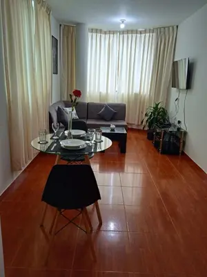 a living room with a table and a couch at 201 Departamento exclusivo en Chorrillos in Lima