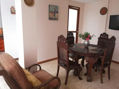 a dining room with a table and chairs at Casa Amarello in Lima