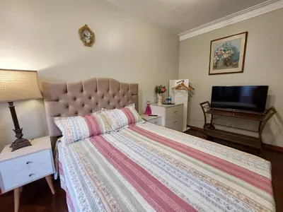 a bedroom with a bed and a flat screen tv at Casa Amarello in Lima