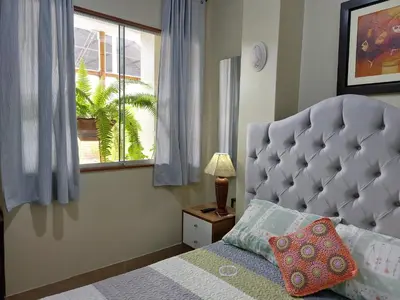 a bedroom with a large bed and a window at Casa Amarello in Lima