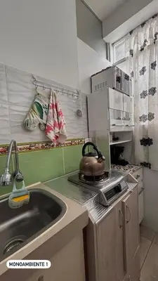 a kitchen with a sink and a tea kettle on a stove at El Viejo Roble in Cusco