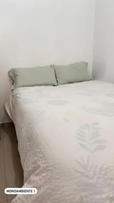 a bedroom with a bed with a white comforter at El Viejo Roble in Cusco