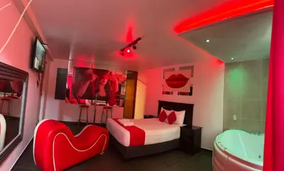 a bedroom with a bed and a tub and red lights at GOLDEN DREAM´S in Lima