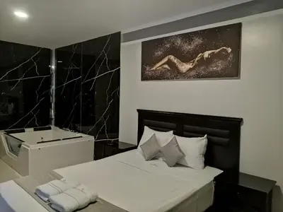 a bedroom with a bed and a bath tub at GOLDEN DREAM´S in Lima