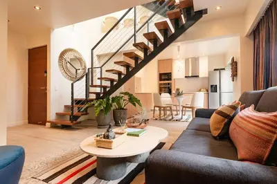 a living room with a couch and a table at ✶ Nazca Penthouse ✶ 3-stories LUXURY Rooftop Pool in Lima