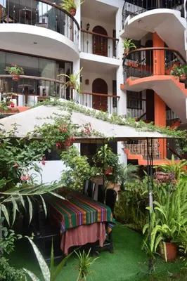 a table in the courtyard of a building at Quilla House Ecologico in Machu Picchu
