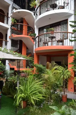 an apartment building with a courtyard with plants at Quilla House Ecologico in Machu Picchu